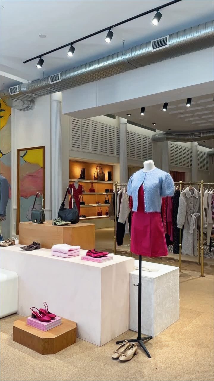 Mid-floor display zone: white plinths, accessory console, an